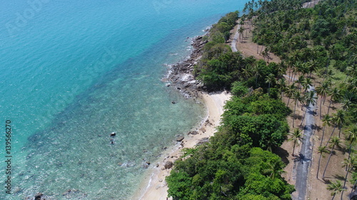 Aerial view of sea coastline and island with palm trees in Phuket, Thailand