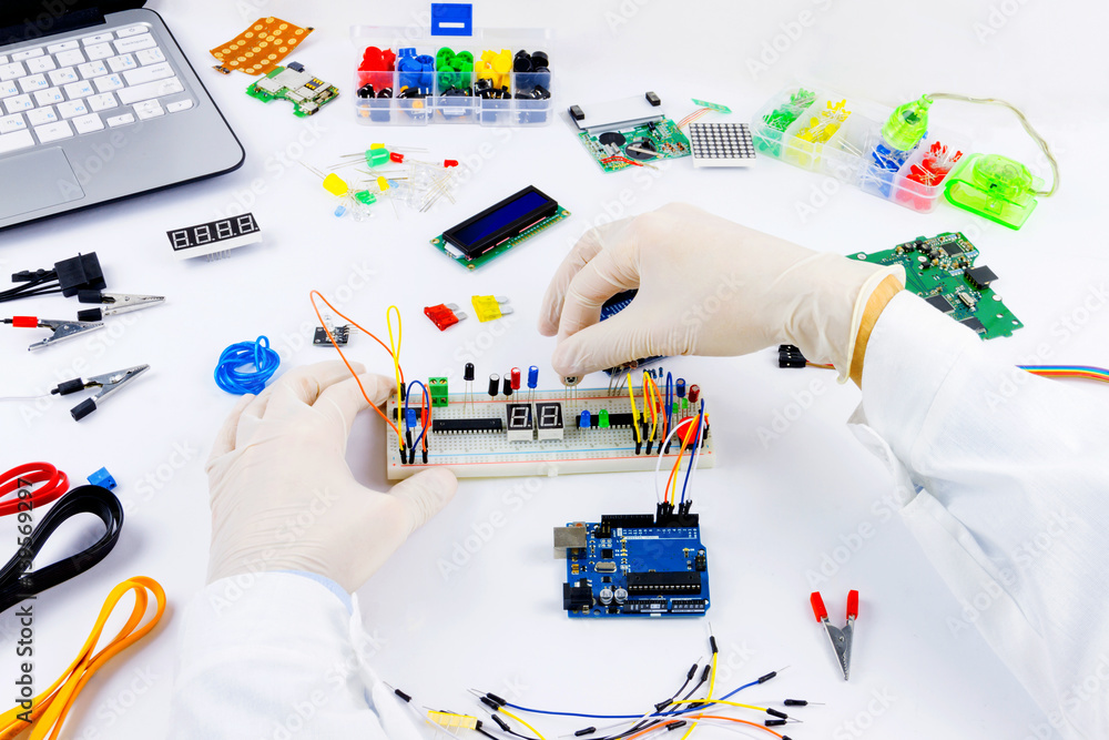 Engineer is connecting microchip to microcontroller mannually