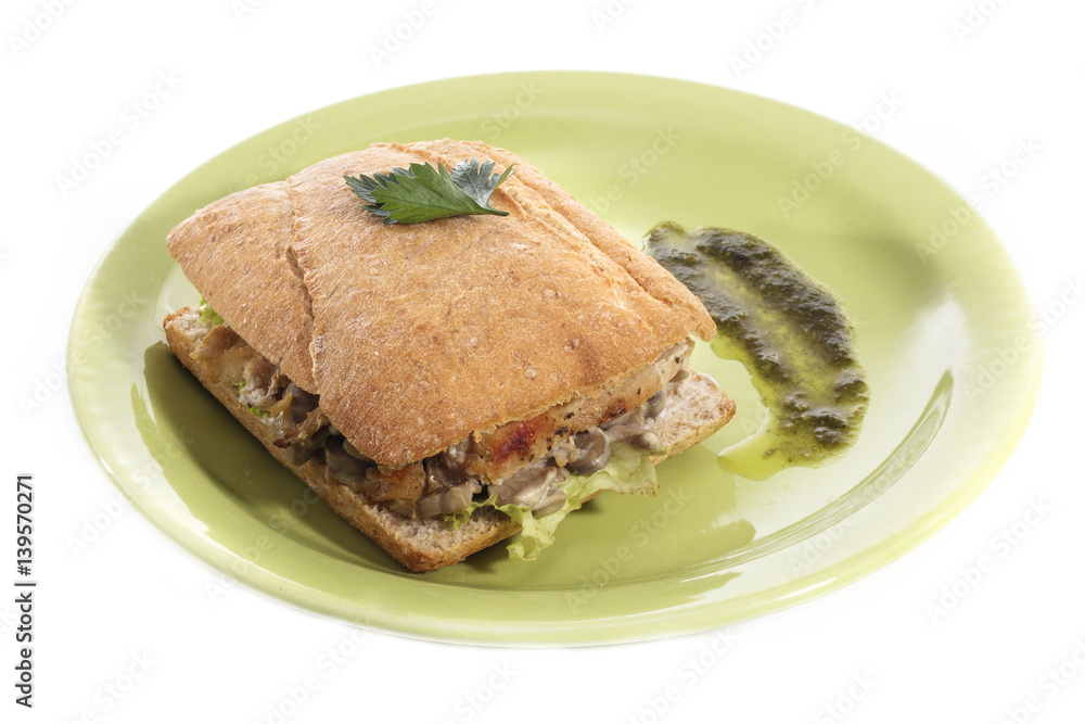 Healthy chicken and mushroom sandwich on green plate over white background Healthy chicken and mushroom sandwich on green plate over white background