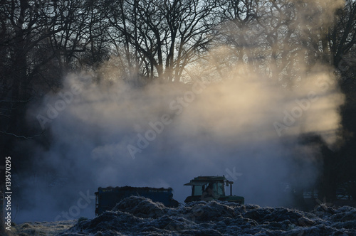 Tractor manure spreading in icy weather