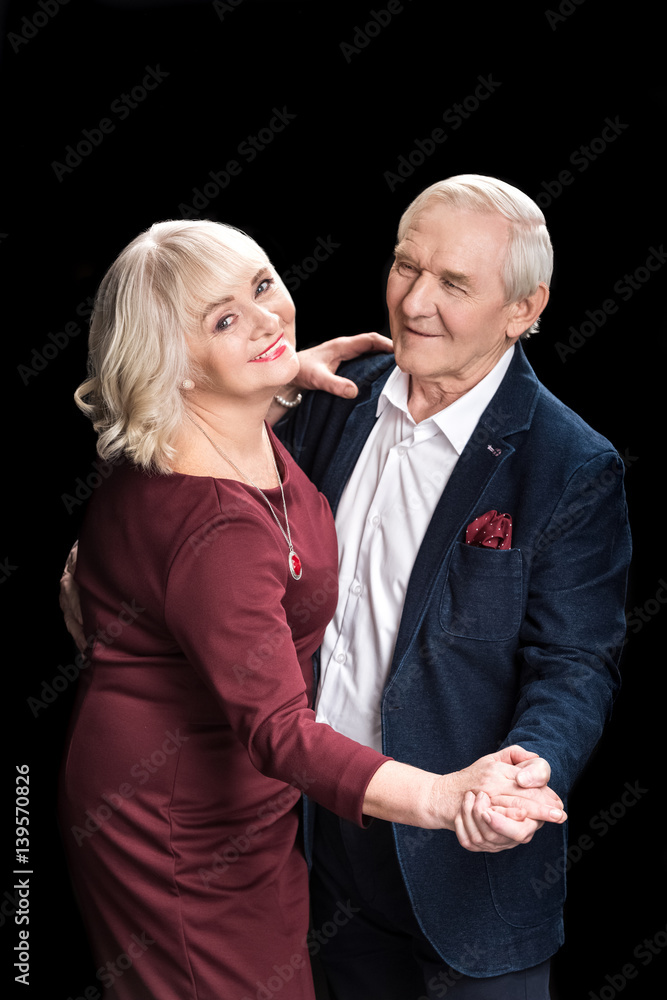 Beautiful happy senior couple dancing on black Beautiful happy senior couple dancing on black