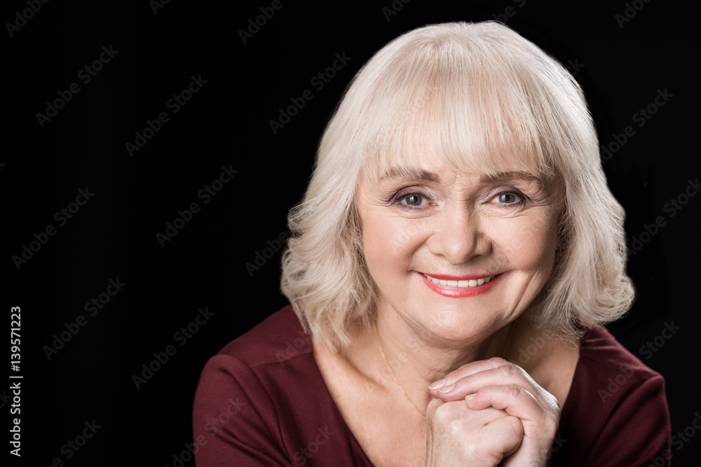 portrait of smiling senior woman with makeup on black portrait of smiling senior woman with makeup on black