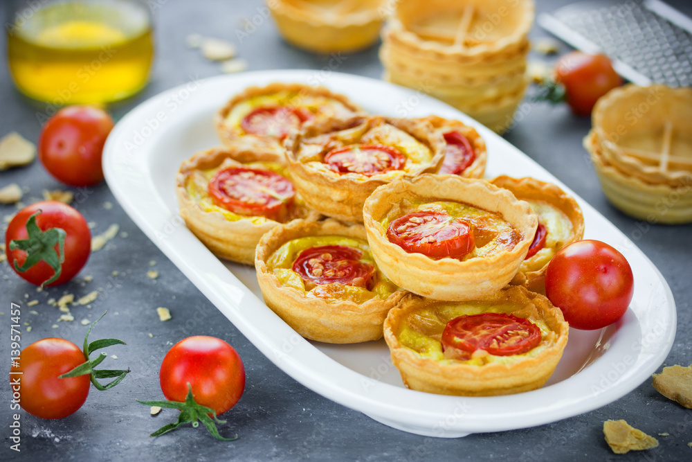 Cheese tomato tartlets , mini-pizzas with cheese and cherry tomatoes Cheese tomato tartlets , mini-pizzas with cheese and cherry tomatoes