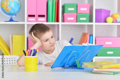 Boy with glasses and books making lessons