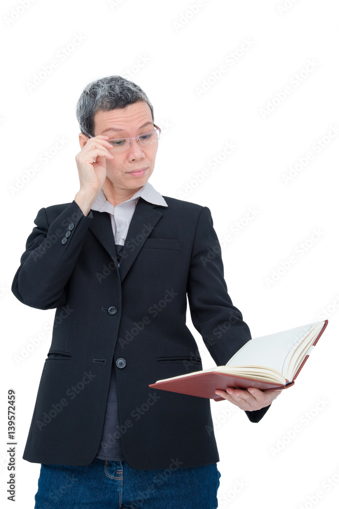 Old asian woman reading book having problem with her eyes