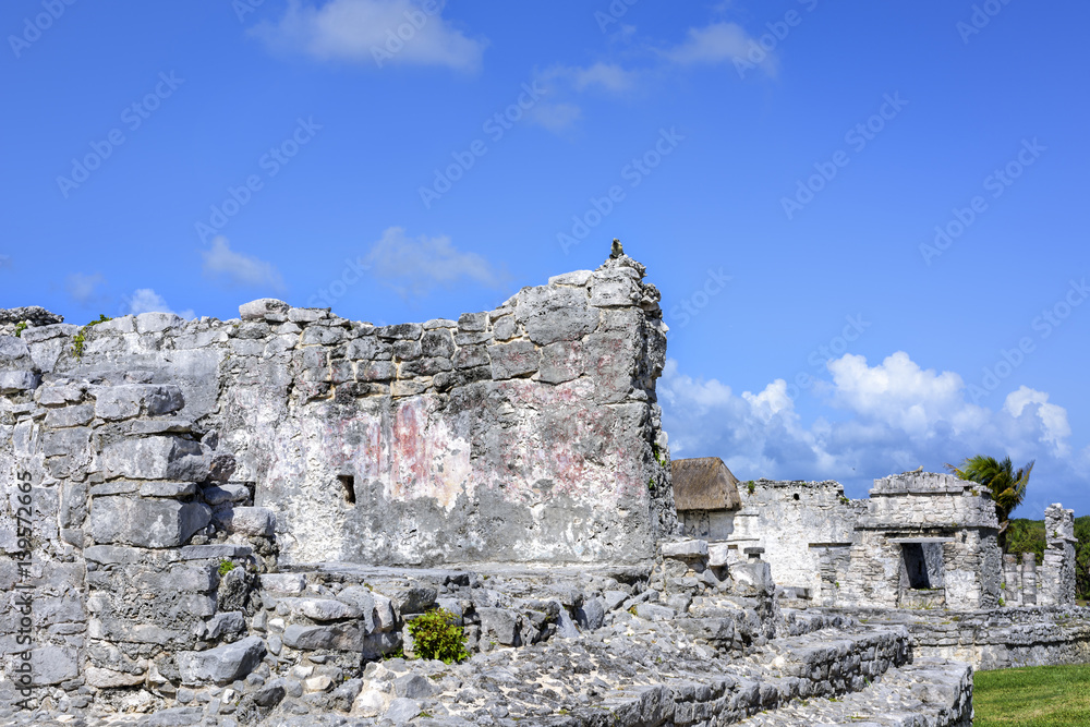 Ancient Mayan building ruins against blue sky in Tulum, Yucatan Peninsula, Mexico