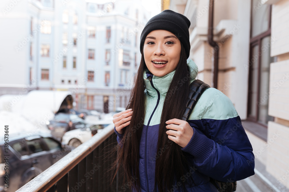 Happy Asian woman in warm clothes