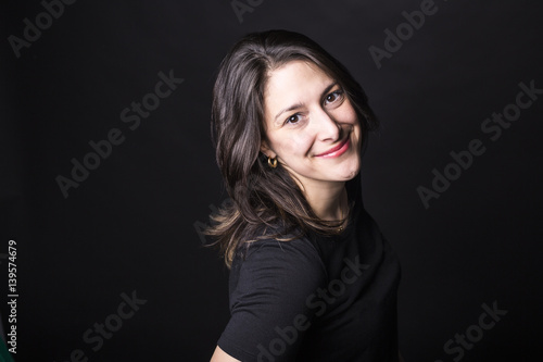 young caucasian woman portrait on black background