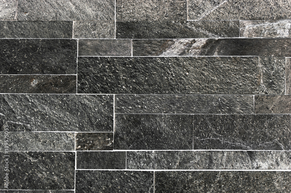 Black or dark Grey stone wall tiles texture.wall pattern design or