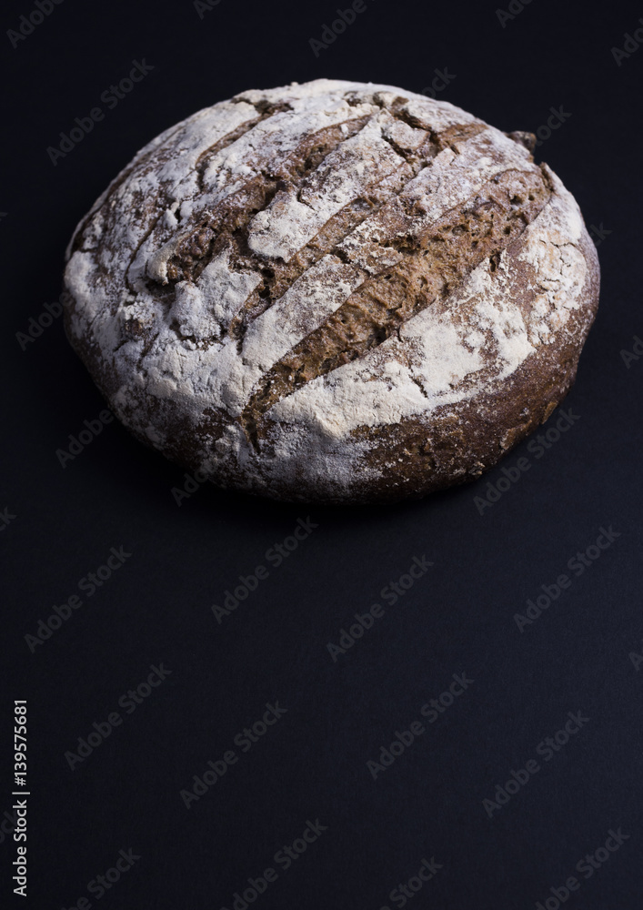 French bread with nuts, pain aux noix, isolated on dark background