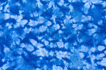 Pattern of blue dye on cotton cloth, Dyed indigo fabric background and textured