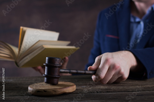 Law and justice concept. Lawer hand, Brown wooden background beautiful reflections. Place for typography and logo