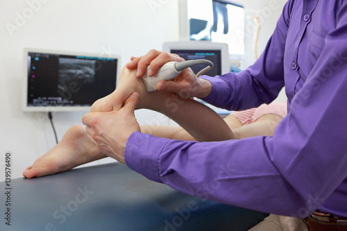 ultrasound of caucasian girl's ankle - diagnosis, close up photo