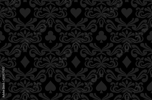 Seamless black background with poker symbols surrounded by floral ornament pattern photo