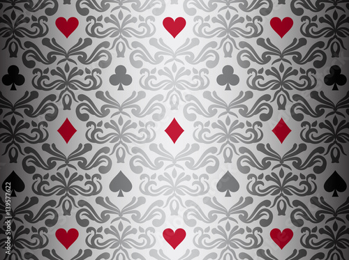 Silver background with poker symbols surrounded by floral ornament pattern