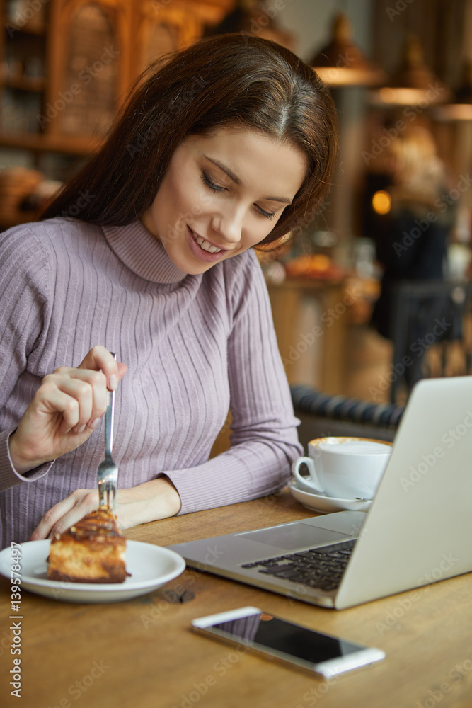 Beautiful brunette using laptop in cafe. Blogger work concept Beautiful brunette using laptop in cafe. Blogger work concept