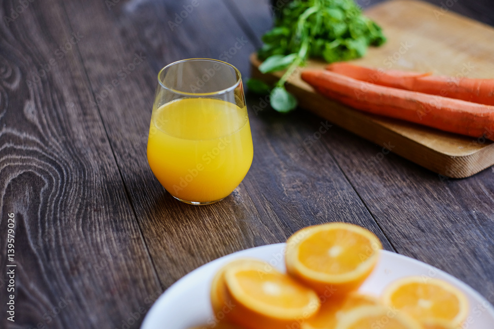 Orange juice in a glass and delicious carrot. Orange juice in a glass and delicious carrot.