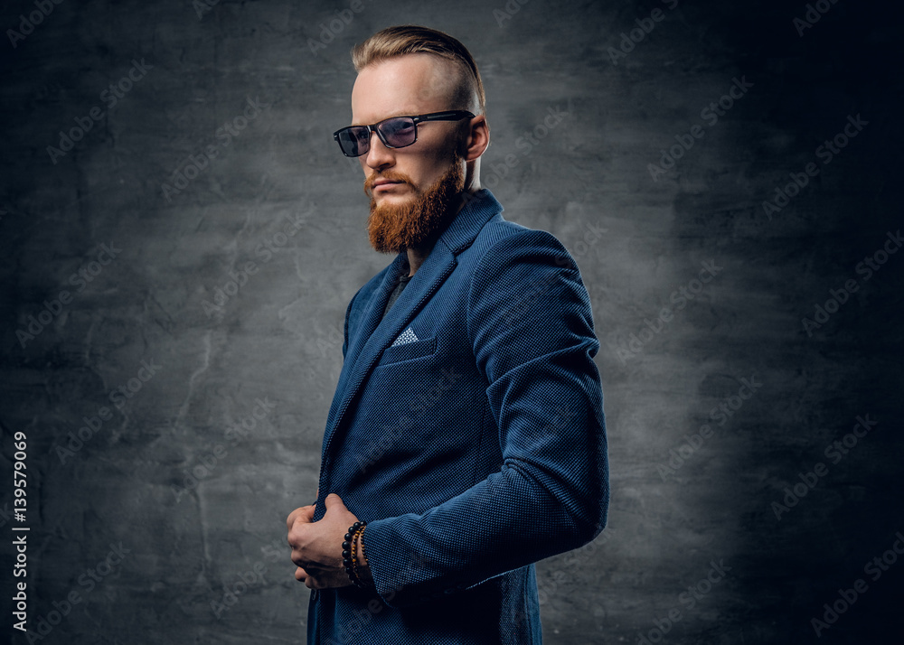 Redhead male dressed in a blue suit and sunglasses. Redhead male dressed in a blue suit and sunglasses.