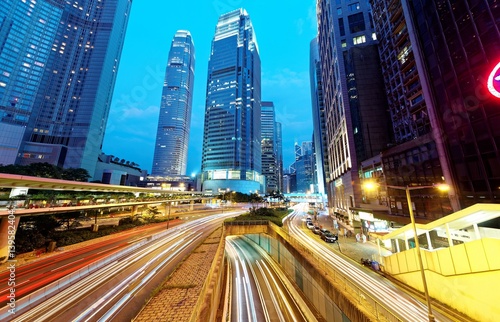 Canvas Print Nightscape of a street corner in Hong Kong with busy traffic trails at rush hour