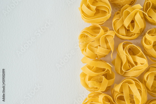 Uncooked italian pasta on a white background