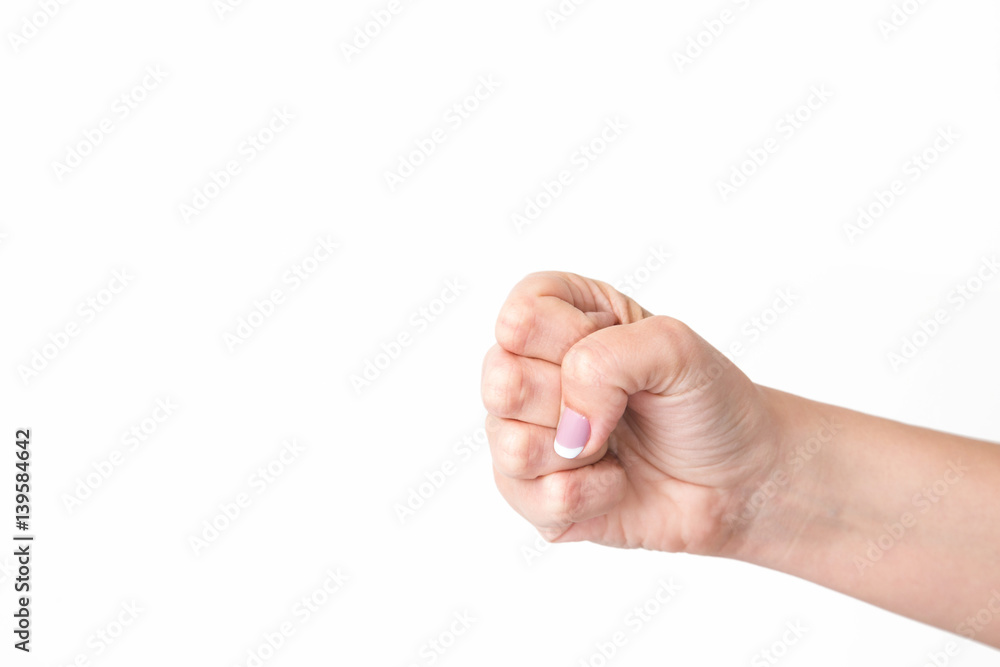 Closeup of female caucasian hand isolated on white background. Young woman forms fist. Horizontal color photography. Closeup of female caucasian hand isolated on white background. Young woman forms fist. Horizontal color photography.