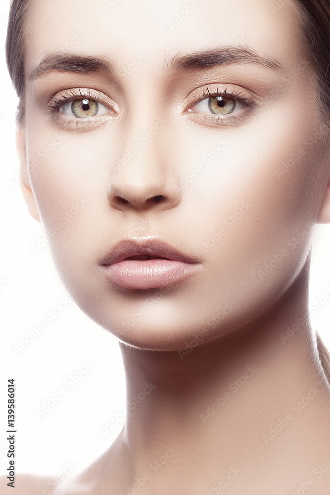 Beautiful face of young caucasian brunette woman with natural lips, nude make-up and perfect skin isolated on white. Studio portrait. Beautiful face of young caucasian brunette woman with natural lips, nude make-up and perfect skin isolated on white. Studio portrait.