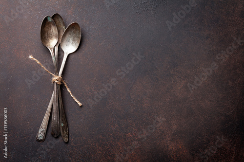 Old vintage spoons on stone table © karandaev
