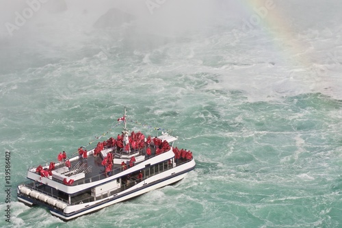 Beautiful isolated photo of a ship near amazing Niagara waterfall photo