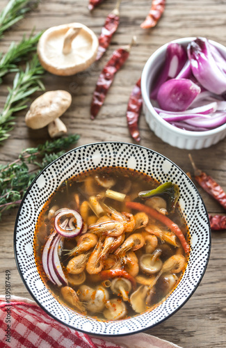 Bowl of thai tom yum soup on the wooden background