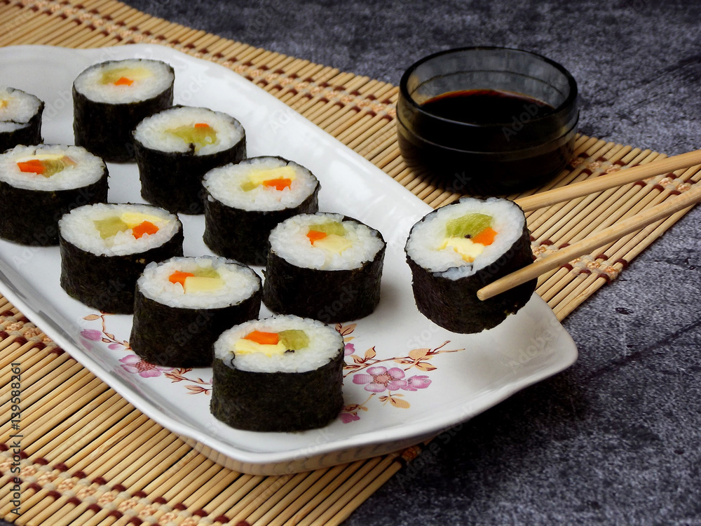Sushi on white plate, grey background. Traditional Asian food. Diet healthy food. Selective focus. Space for text Sushi on white plate, grey background. Traditional Asian food. Diet healthy food. Selective focus. Space for text