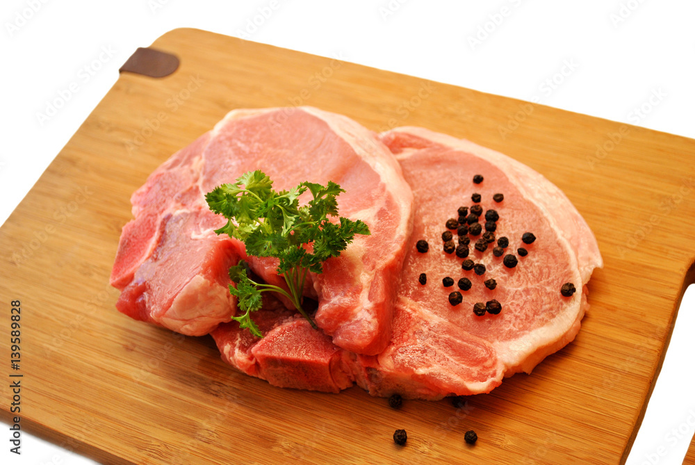 Fresh Lean Pork Chops on a Cutting Board Fresh Lean Pork Chops on a Cutting Board