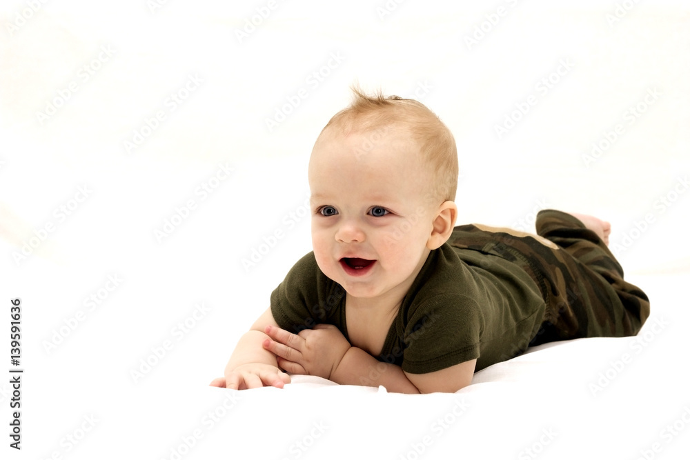 Smiling infant child lying on the white blanket Smiling infant child lying on the white blanket