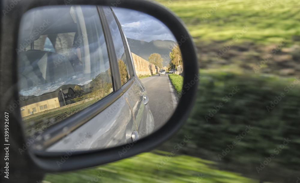 Italian landscape from the rearview of a car