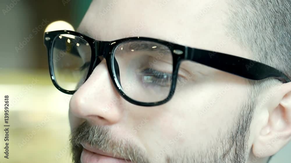 Handsome man wearing glasses with black frame and looks stylish, close up, steadycam shot
Handsome man wearing glasses with black frame and looks stylish, close up, steadycam shot