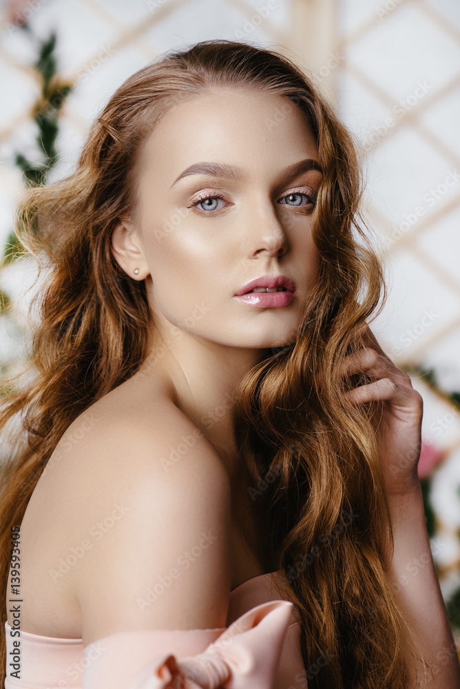 Naklejka premium Portrait of a beautiful fashion, sweet and sensual. make up and hair. Perfect Skin. Flowers background. Art modern style. Blue eyes. Natural manicure.