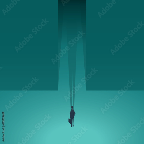 Businessman standing in front of dark corridor as a symbol of business adventure, risk, challenge, opportunity in professional career.