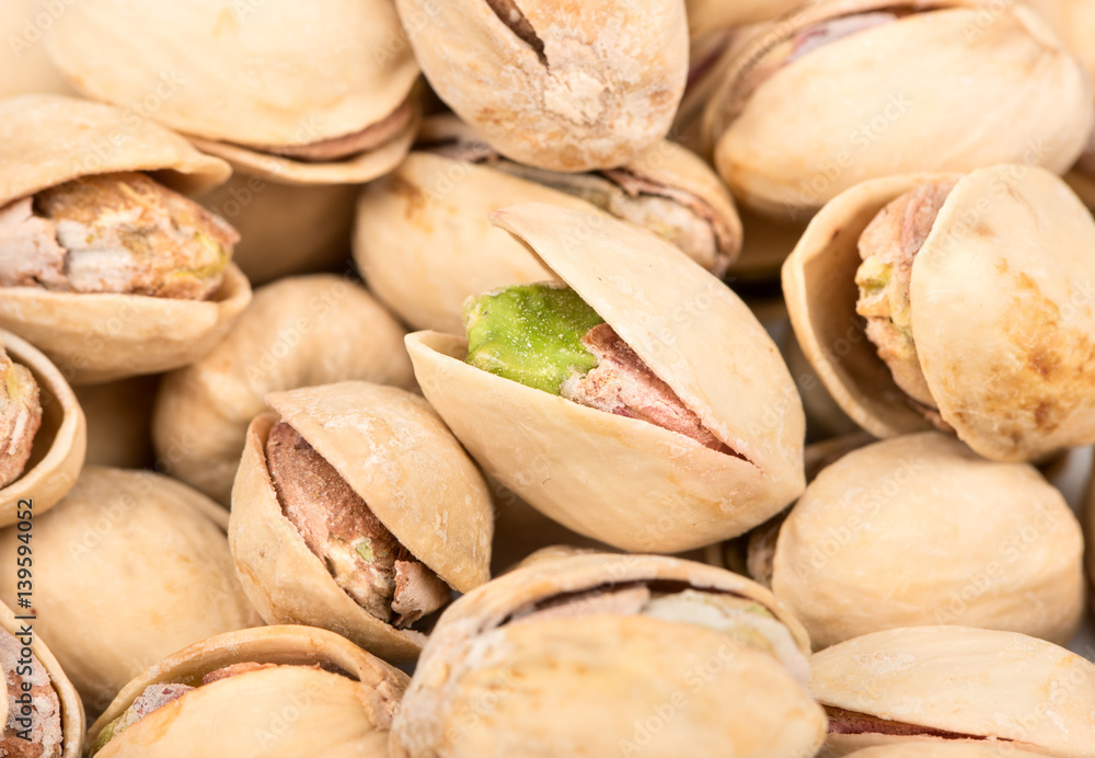 Pile of salted pistachio nuts close up Pile of salted pistachio nuts close up