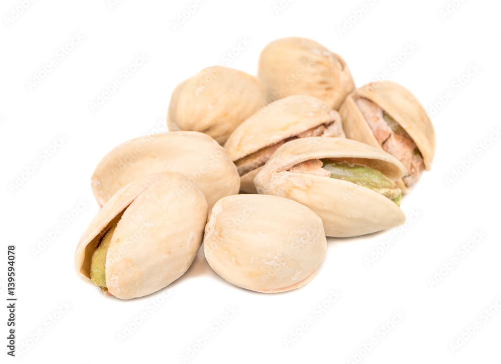 Several pistachio nuts on a white background Several pistachio nuts on a white background