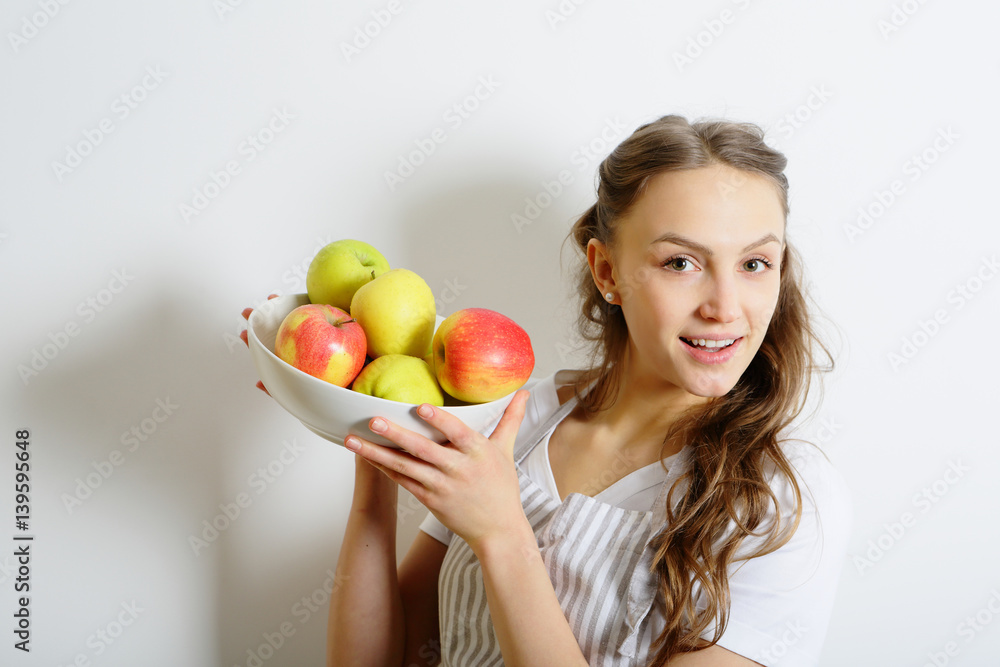 Young girl and fresh apples, healthy lifestyle, on white background Young girl and fresh apples, healthy lifestyle, on white background
