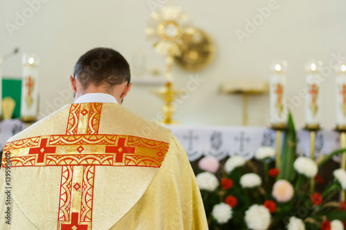 Fototapeta Indoor portrait of Catholic priest from back