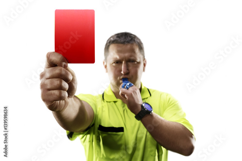 Professional soccer referee giving the red card isolated