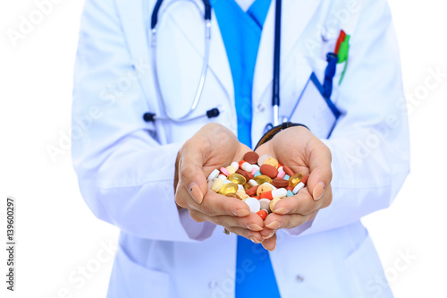 Doctor holding heap of drugs in a hand