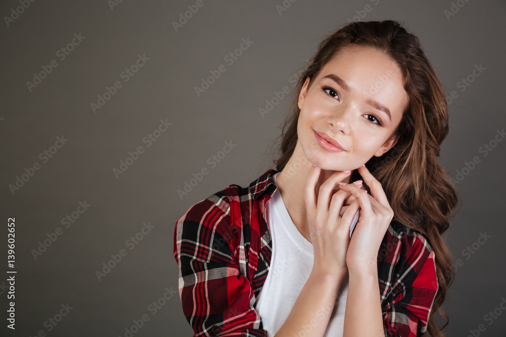 Happy lovely young woman in plaid shirt standing and smiling Happy lovely young woman in plaid shirt standing and smiling