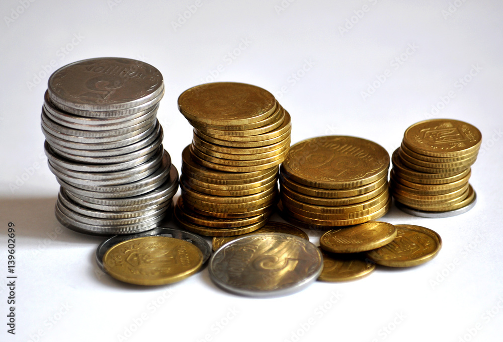 On the Ukrainian piles are metallic silver coins and yellow on a light background On the Ukrainian piles are metallic silver coins and yellow on a light background