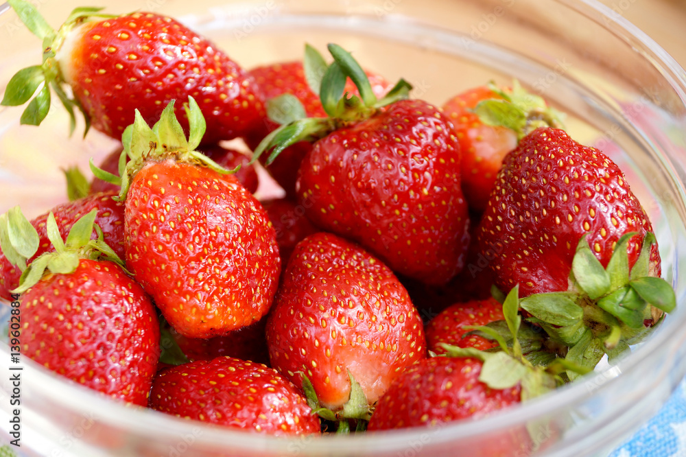 Fresh strawberry in a transparent salad bowl Fresh strawberry in a transparent salad bowl