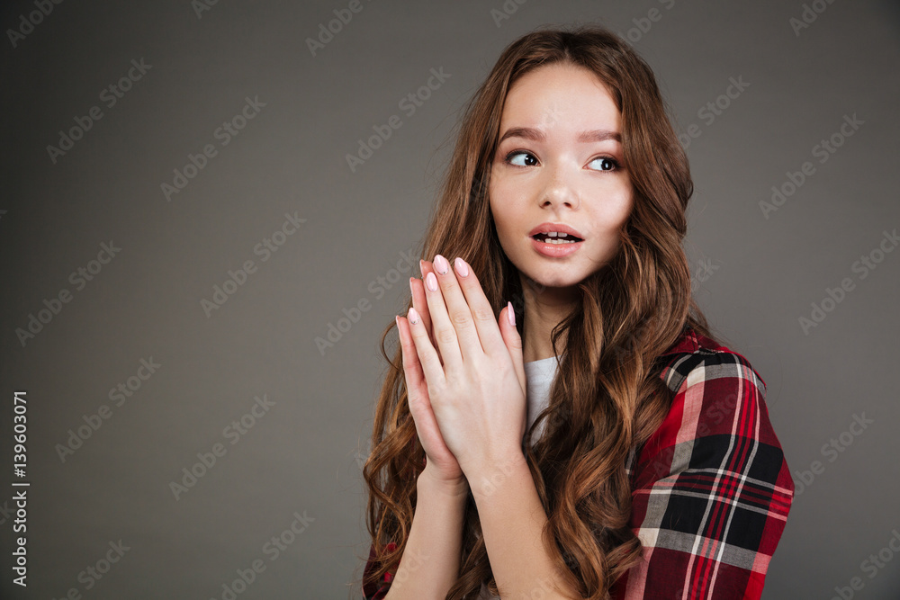Amazed cute young woman with opened mouth looking away Amazed cute young woman with opened mouth looking away