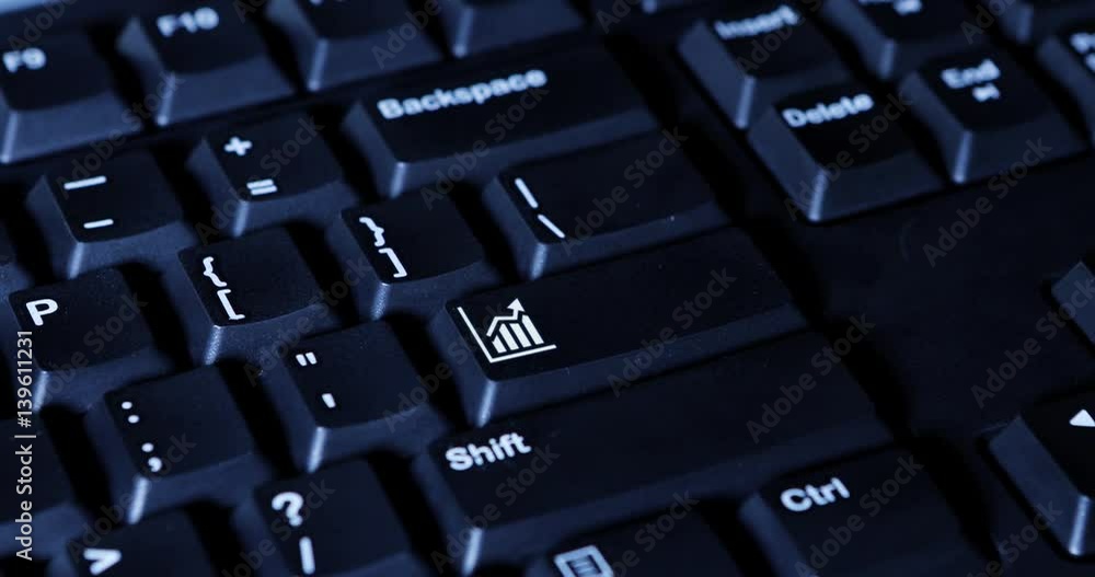 Macro of human finger pressing a chart key on the computer keyboard Macro of human finger pressing a chart key on the computer keyboard