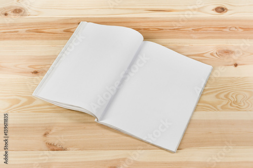 Mock-up magazine or catalog on natural wooden table. Blank page or notepad on wood background. Blank page or notepad for mockups or simulations.