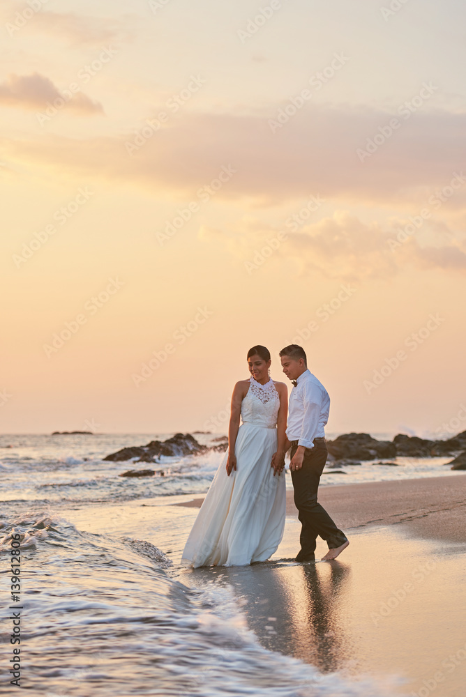 Married couple on beautiful sunset background