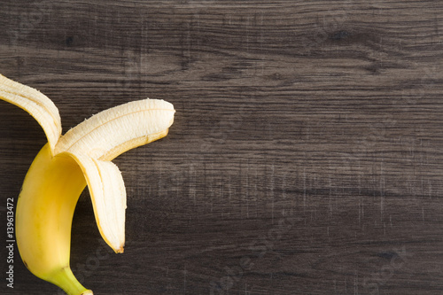 Banana on the wooden table in the kitchen. Healthy eating and lifestyle.
